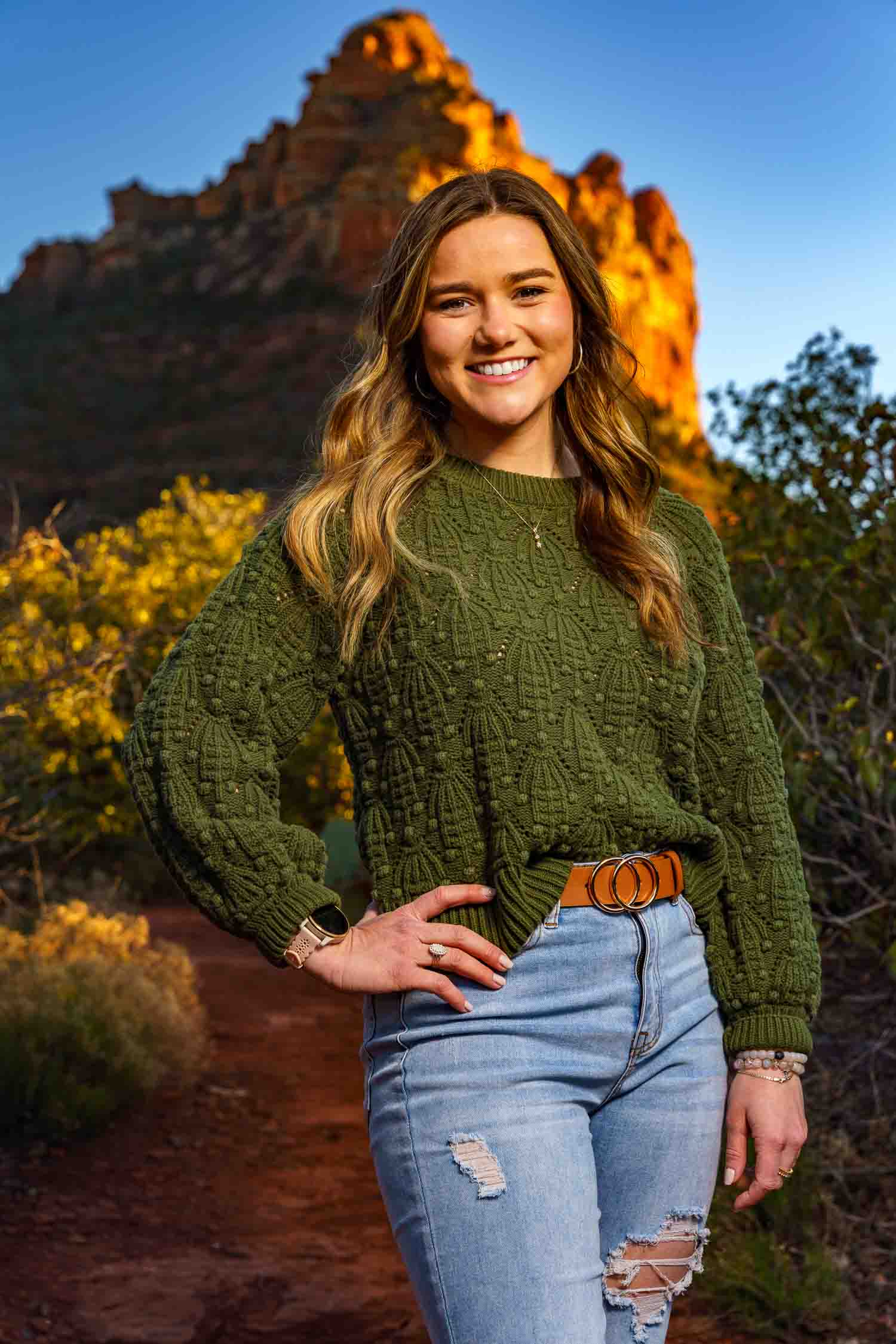 woman-cowboy-hat sunrise photo of a couple proposing at devils bridge in Sedona, Arizona