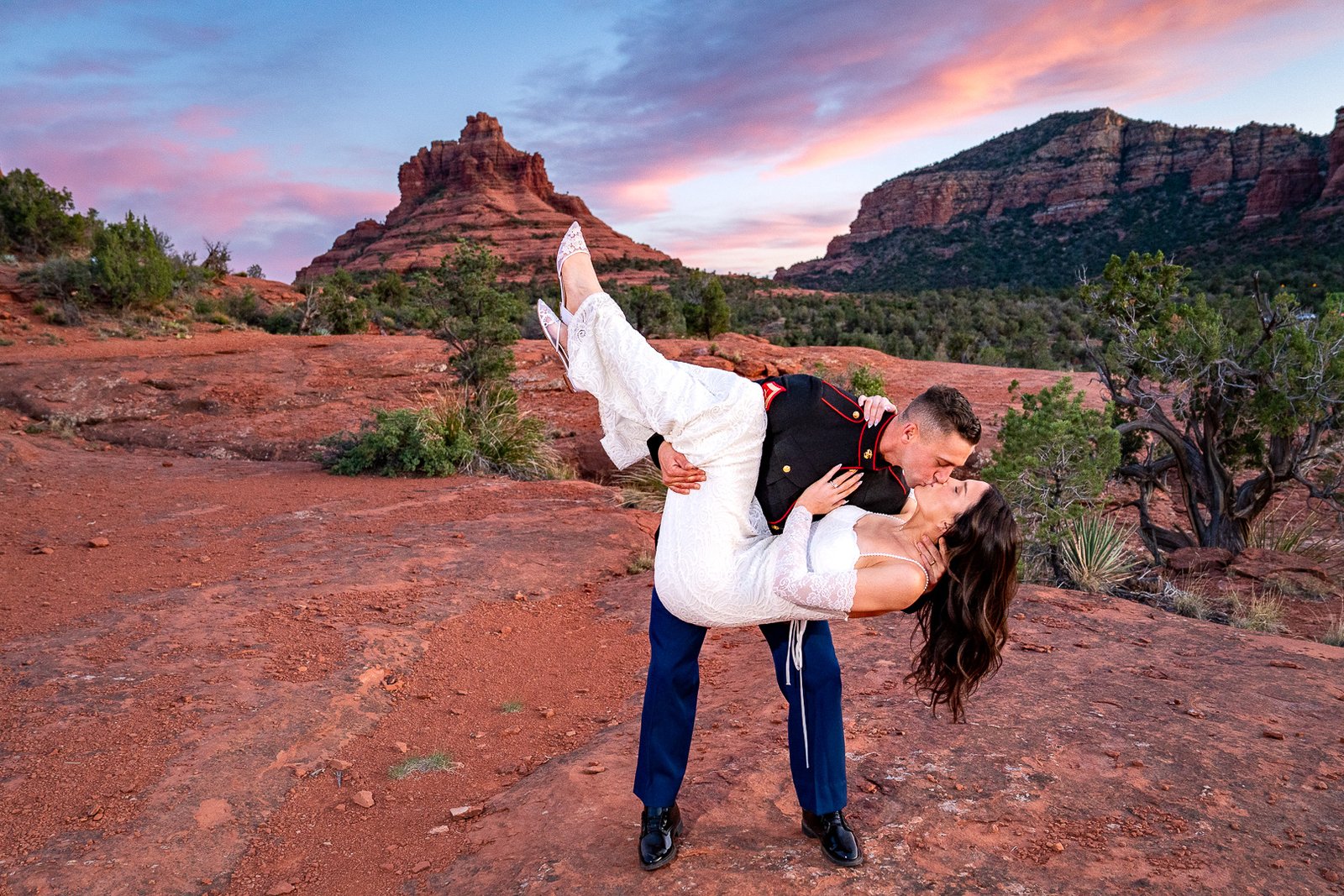 A man proposing on one knee next to Oak Creek in front of Cathedral Rock in Sedona.